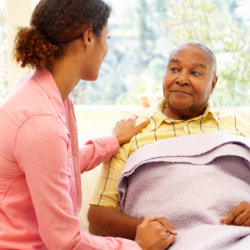 caregiver holding the shoulder of patient